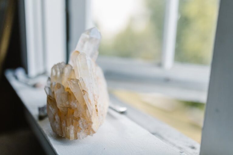 Close-up of a natural quartz crystal cluster on a sunny windowsill, evoking tranquility.