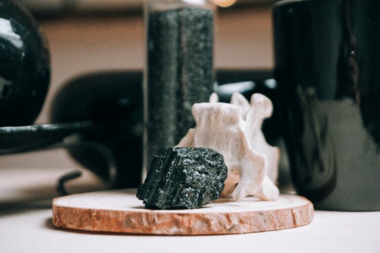 Wooden round shaped board with textured black stone on blurred background of magic interior